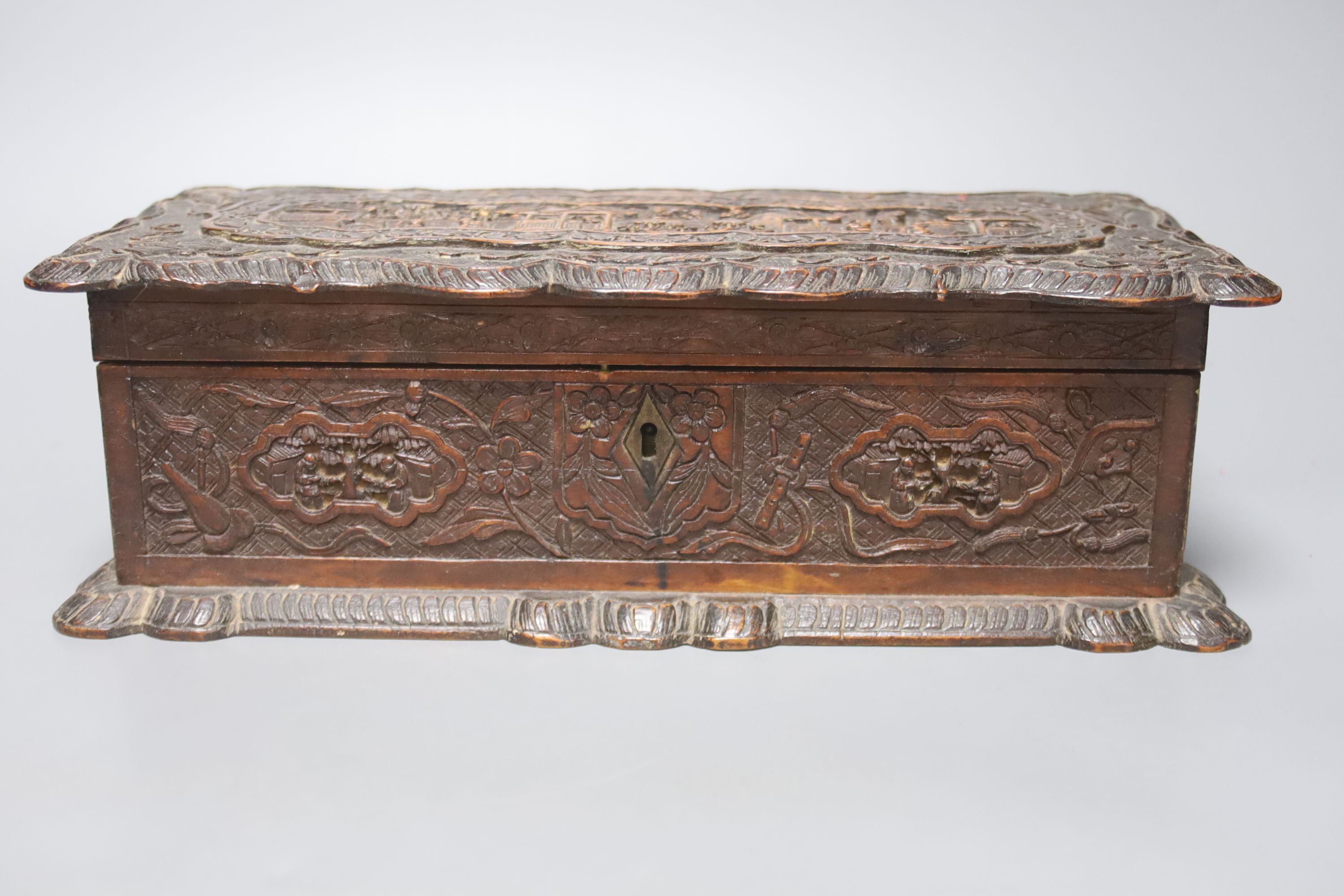 Two 19th century Chinese carved sandalwood boxes, together with a similar puzzle box, length 27cm